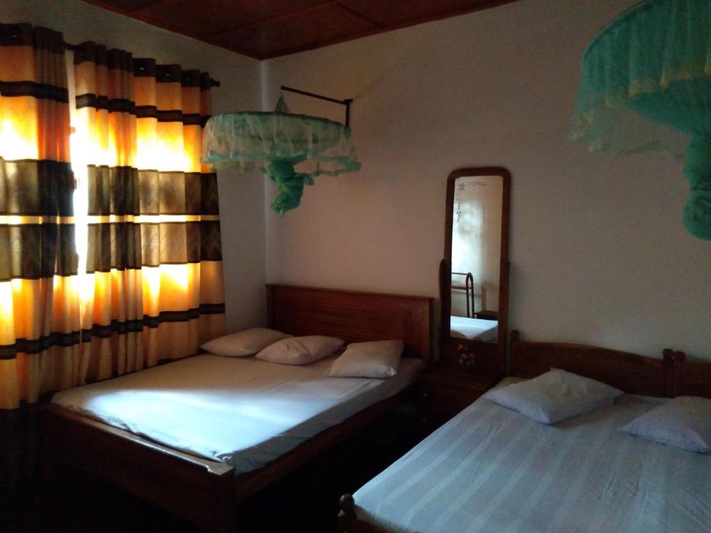 Postel nebo postele na pokoji v ubytování Kumudu Holiday Home