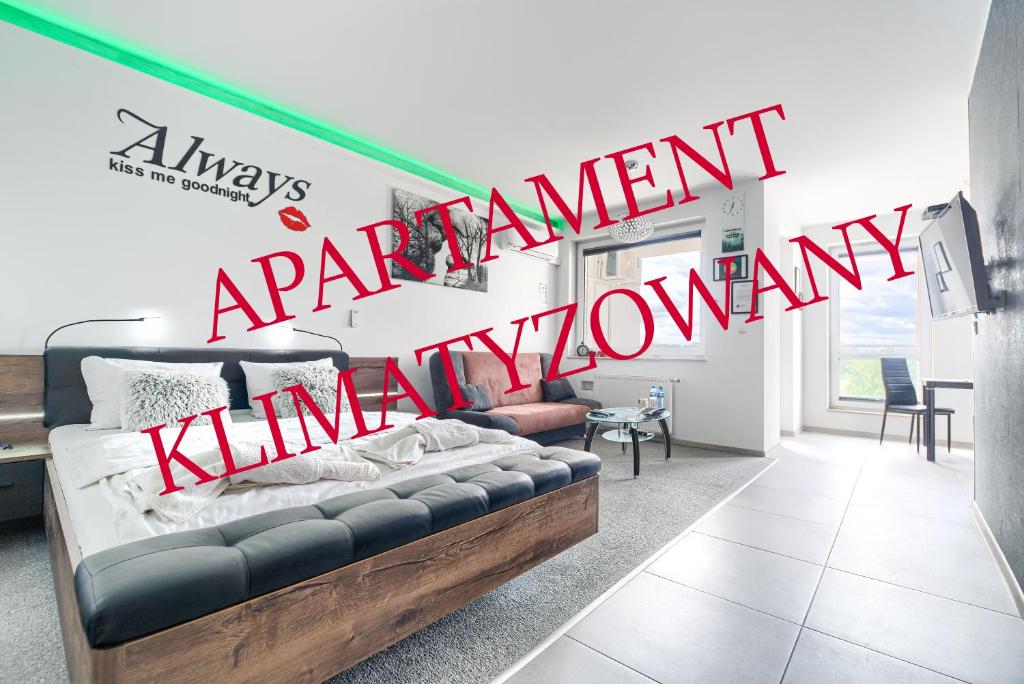 a living room with a couch and a sign that reads unemployment at Top Oder Apartments- private parking in Szczecin
