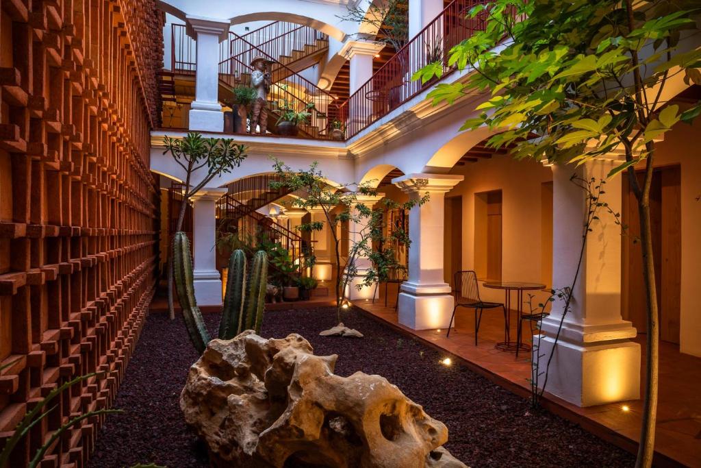 a library with a large rock in the middle at AYOOK in Oaxaca City