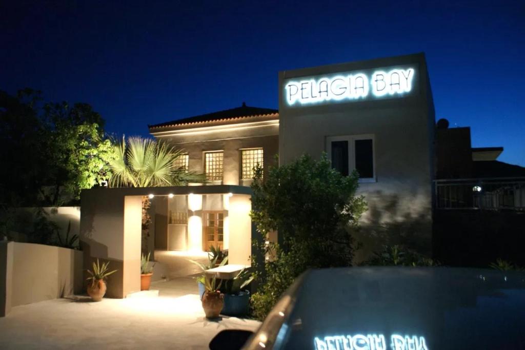 a house with a car parked in front of it at Pelagia Bay Hotel in Agia Pelagia
