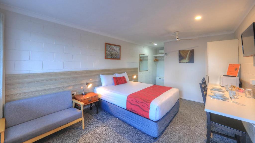 a hotel room with a bed and a desk at Boonah Motel in Boonah