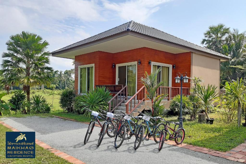 a group of bikes parked in front of a house at MaiKhao Residence in Mai Khao Beach