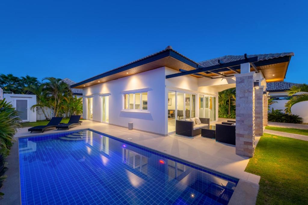 eine Villa mit einem Pool in der Nacht in der Unterkunft Orchid Paradise Homes OPV 406 in Hua Hin