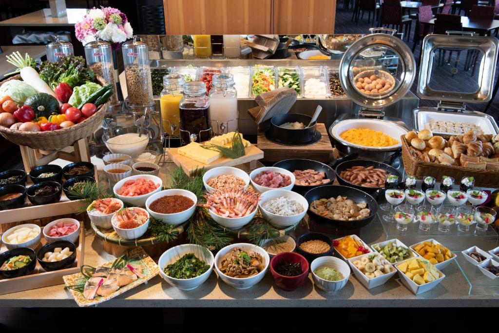 a buffet with many different types of food on a table at Jodogahama Park Hotel in Miyako