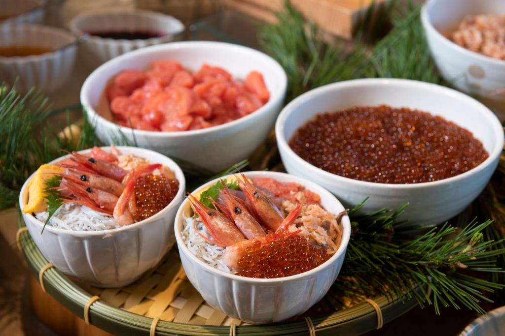 a group of bowls of food on a table at Jodogahama Park Hotel in Miyako