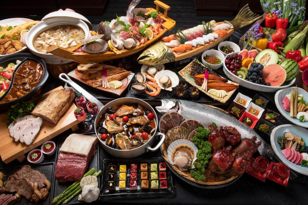 a table filled with lots of different types of food at Jodogahama Park Hotel in Miyako