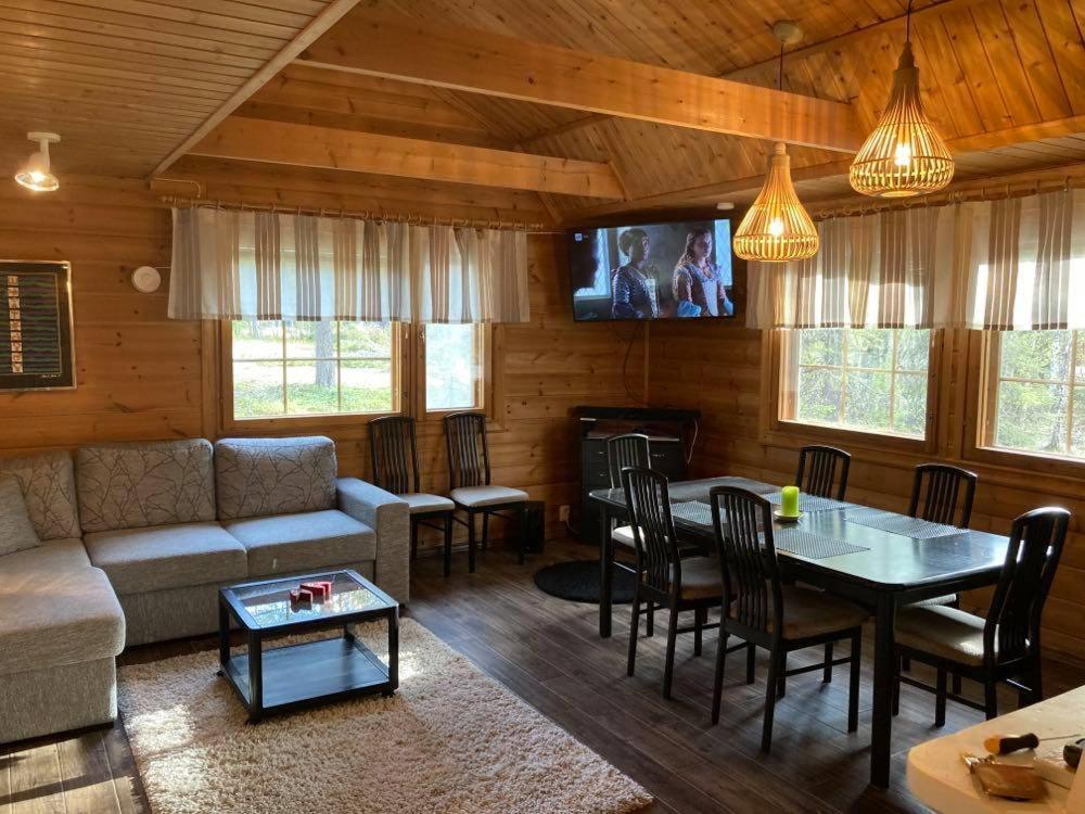 a living room with a couch and a table at Villa Casanova in Levi