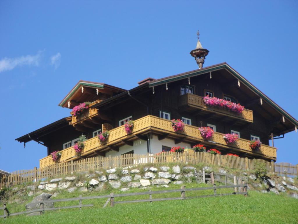 a house on top of a hill with flowers at Brandebengut in Bad Hofgastein