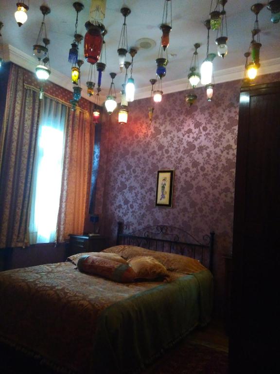 a bedroom with a bed with a purple wall at Kybele Hotel in Istanbul
