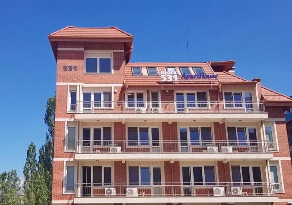 a tall brick building with balconies on top of it at BLOCK 531 ApartHouse BLOCK 533 in Sofia