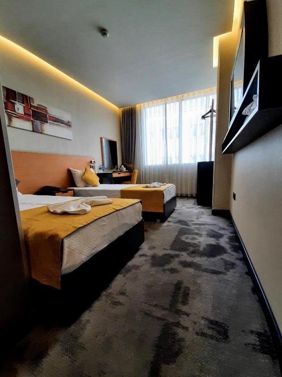Postel nebo postele na pokoji v ubytování Sapko Airport Hotel