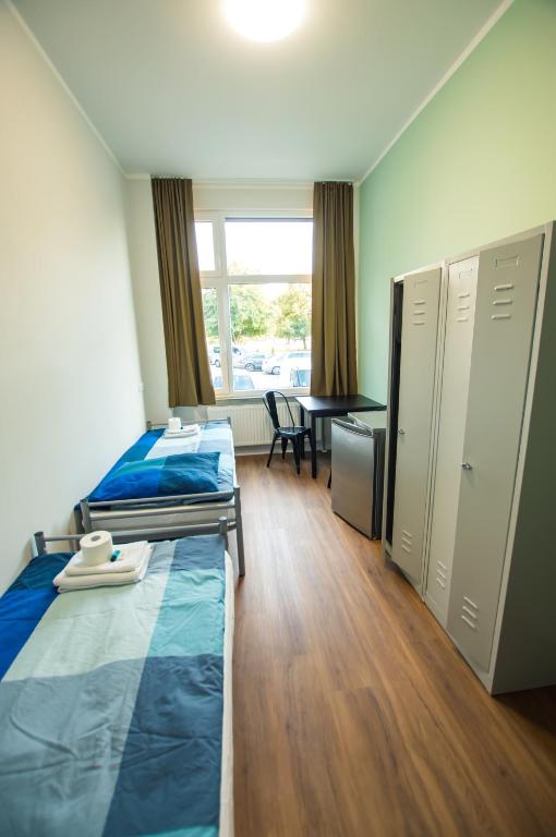 Postel nebo postele na pokoji v ubytování NeoHostel