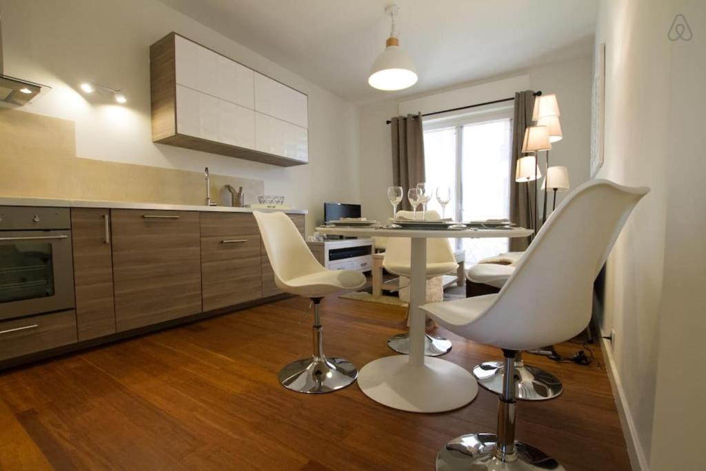 a kitchen with two white chairs and a table at Pretty 3 rooms in the city center in Annecy