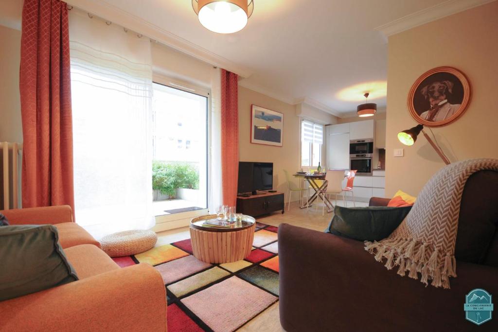 a living room with two couches and a large window at Annecy Lake - Le Saint Bernard - 2 min walk from the lake in Annecy