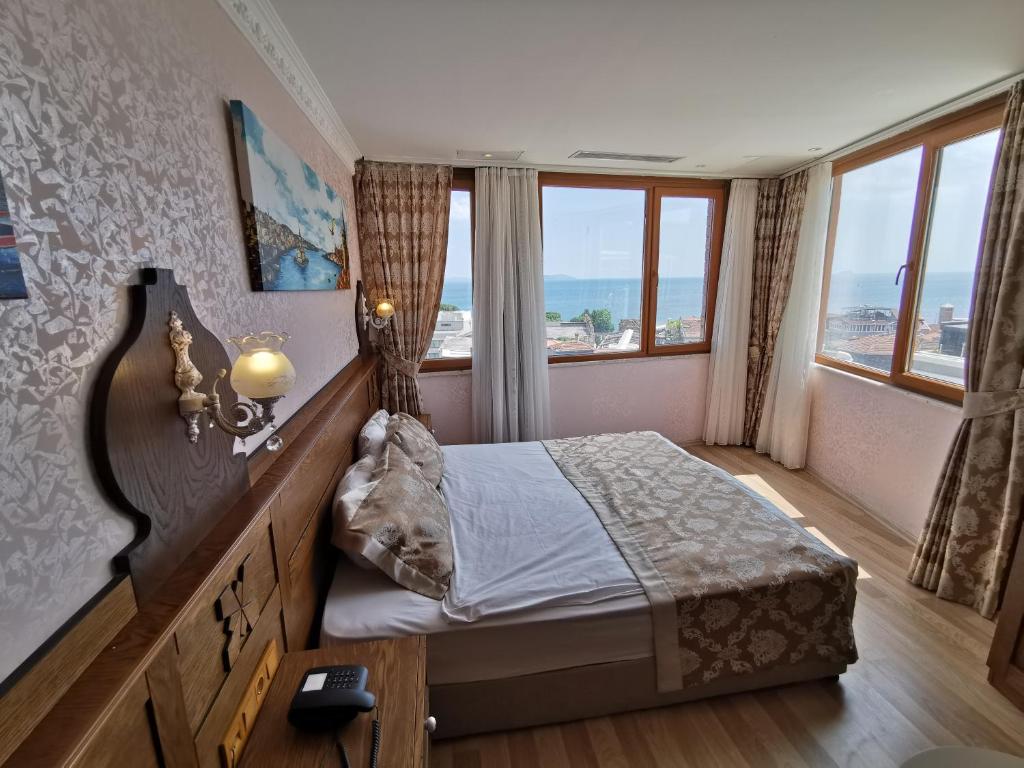 a bedroom with a bed with a view of the ocean at Perapolis Hotel in Istanbul