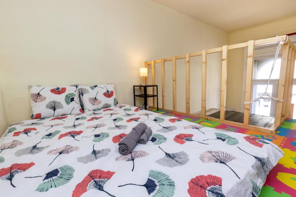 a bedroom with a bed with a bedspread with butterflies at Budapest Three Cats Hostel in Budapest