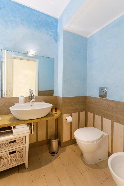 a bathroom with a sink and a toilet at Hotel La Villa Del Mare in Cagliari