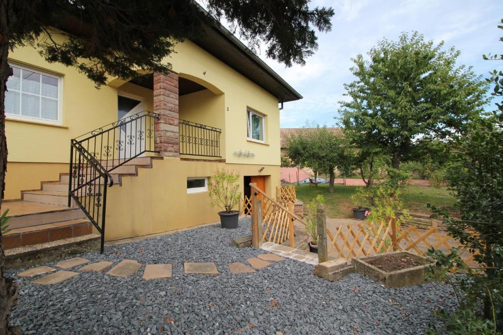 a house with a staircase in front of it at Les Lauriers de la route des vins in Orschwihr