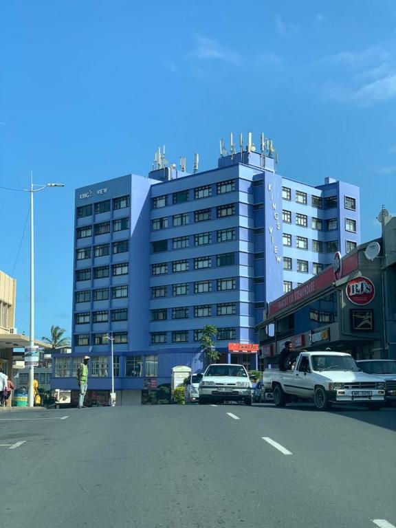 a large building with cars parked in a parking lot at Kings View in Margate