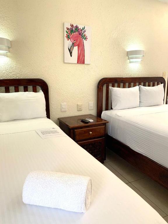 Postel nebo postele na pokoji v ubytování Hotel Caribe
