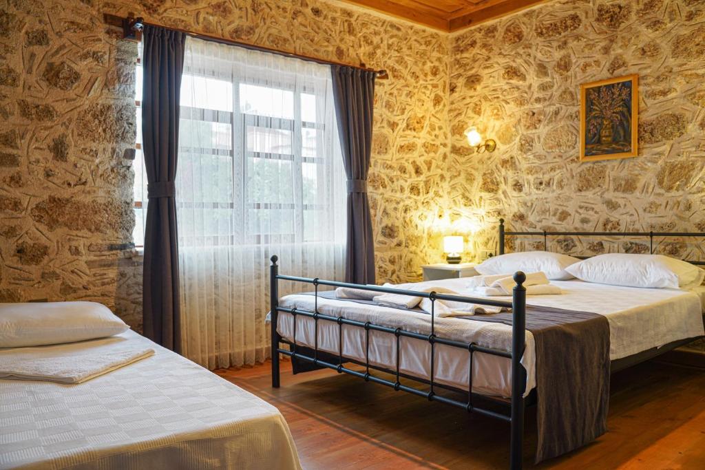 a bedroom with two beds and a window at La Casa Carina in Antalya