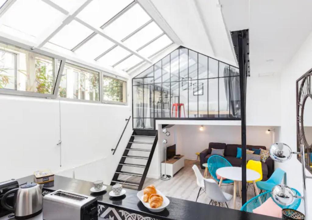 a kitchen and living room with a loft conversion at Atelier d Artiste Le Marais Paris - exceptionnel ! in Paris
