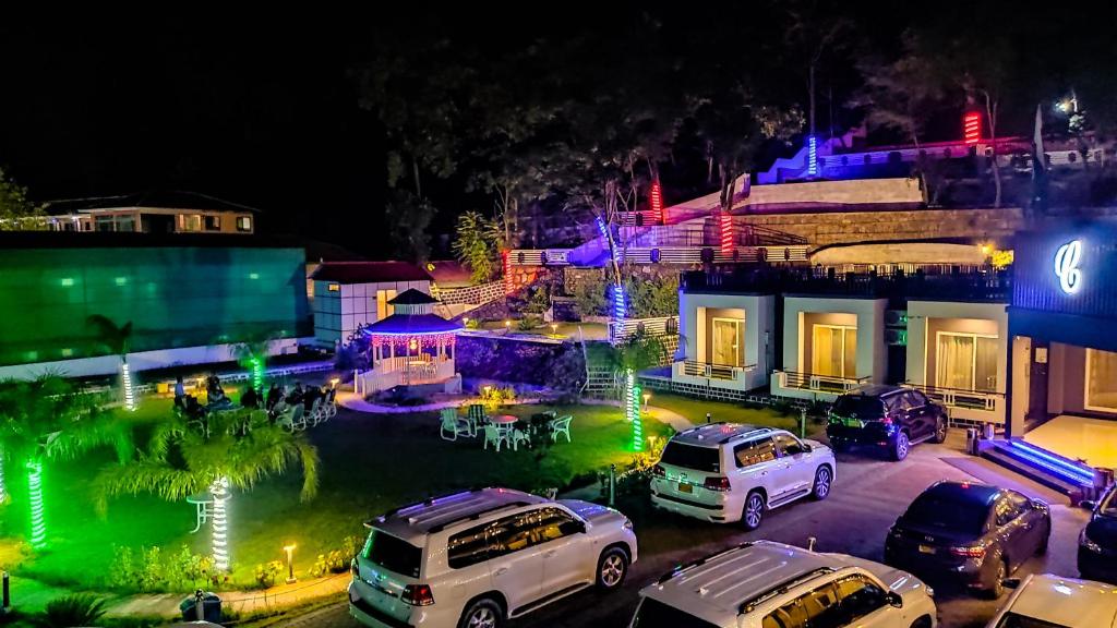 a group of cars parked in a parking lot at night at Cordillera Resort in Hassa