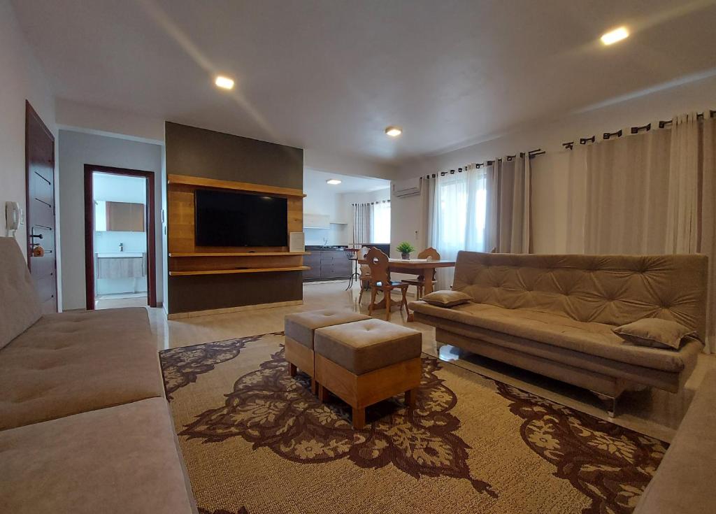 a living room with a couch and a table at San Michael Hospedaria in Treze Tílias