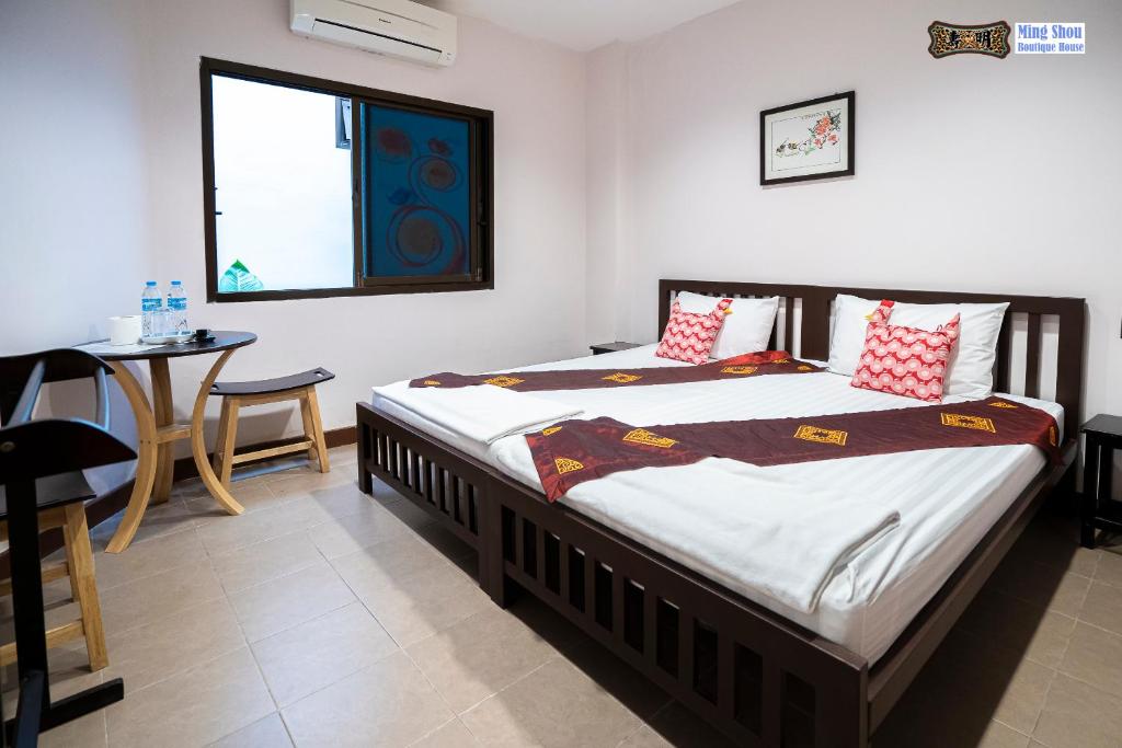 Postel nebo postele na pokoji v ubytování Ming Shou Boutique House