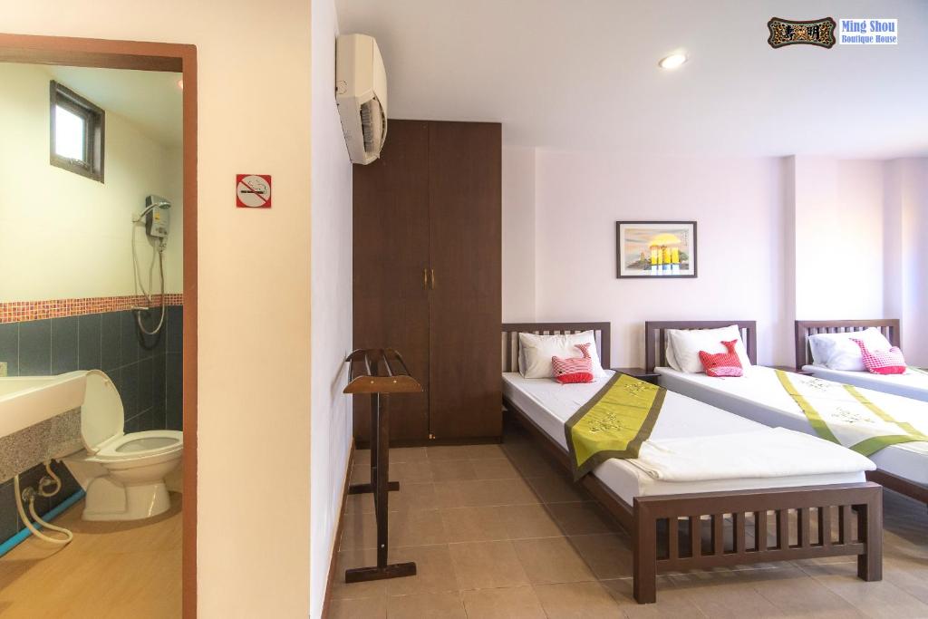 Postel nebo postele na pokoji v ubytování Ming Shou Boutique House