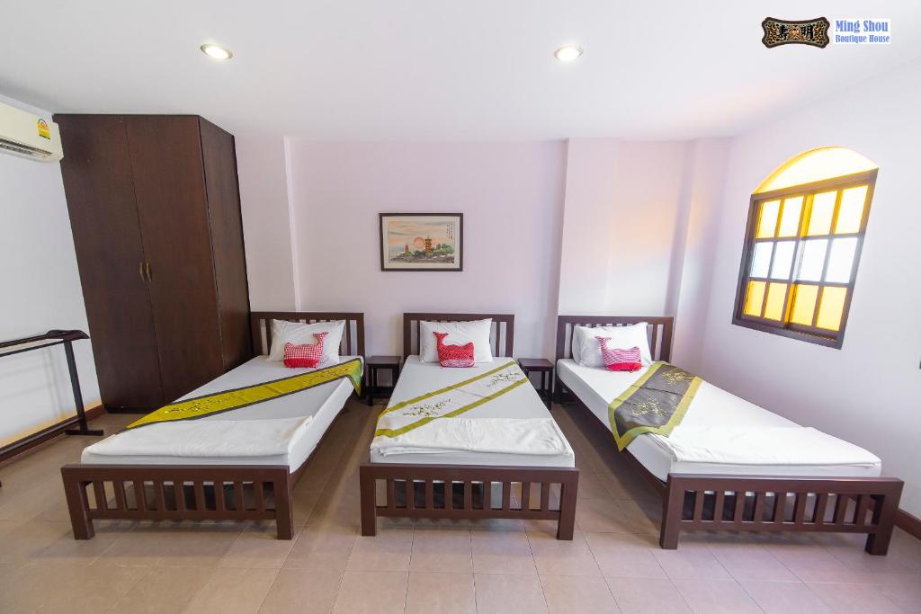 Postel nebo postele na pokoji v ubytování Ming Shou Boutique House