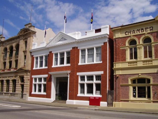 a red brick building on a city street at Fremantle Harbourside Luxury Apartments in Fremantle