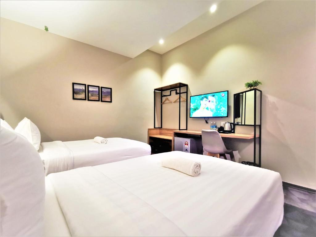 Postel nebo postele na pokoji v ubytování Prestigo Hotel - Johor Bharu