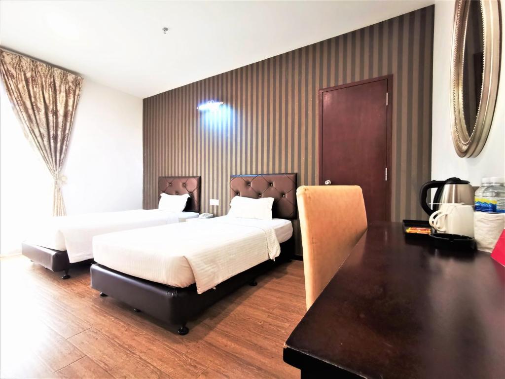 Postel nebo postele na pokoji v ubytování Koho Hotel - Johor Bahru