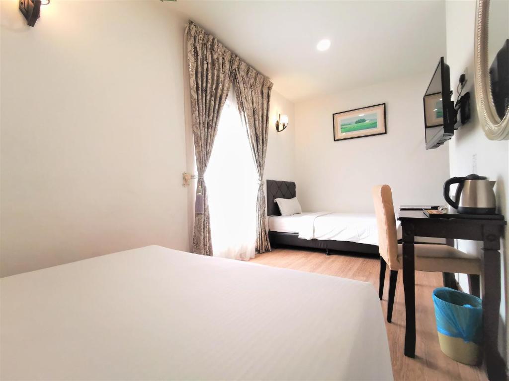 Postel nebo postele na pokoji v ubytování Koho Hotel - Johor Bahru