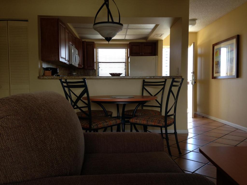 a dining room and kitchen with a table and chairs at Surfsider Resort - A Timeshare Resort in Pompano Beach