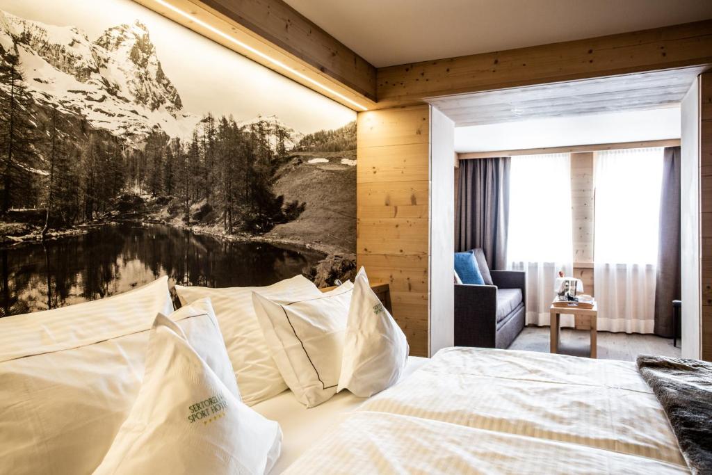 Postel nebo postele na pokoji v ubytování Sertorelli Sporthotel