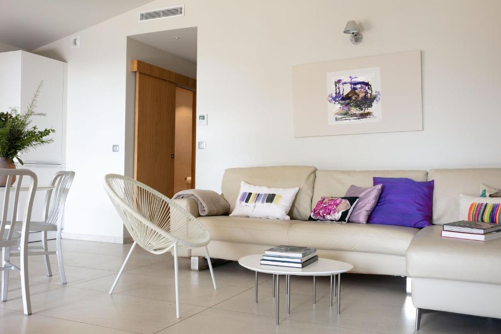 a living room with a couch and a table and chairs at Domaine Santa Giulia Palace in Porto-Vecchio