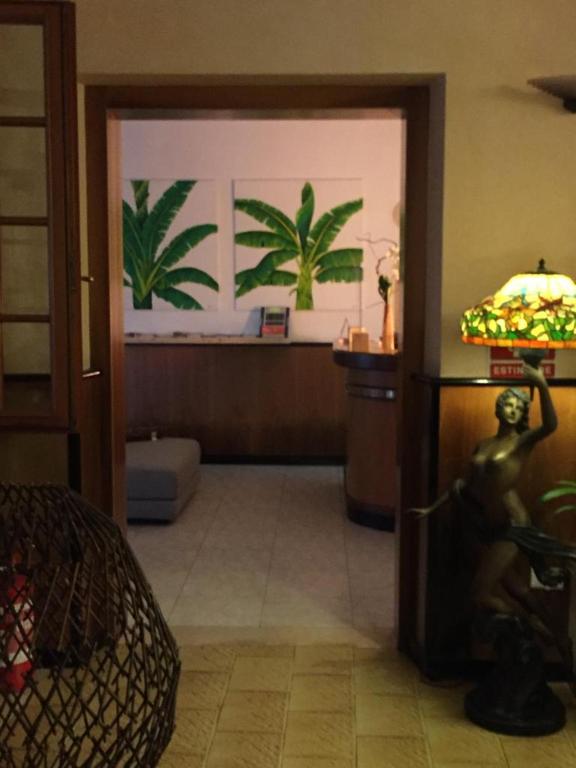 a room with a bedroom with plants on the wall at Hotel La Favorita in Peschiera del Garda