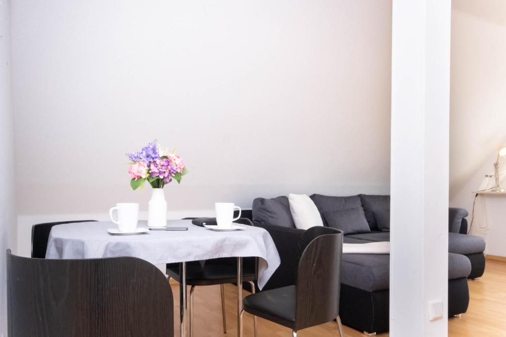 a living room with a table and a couch at Schönebeck Apartment in Essen