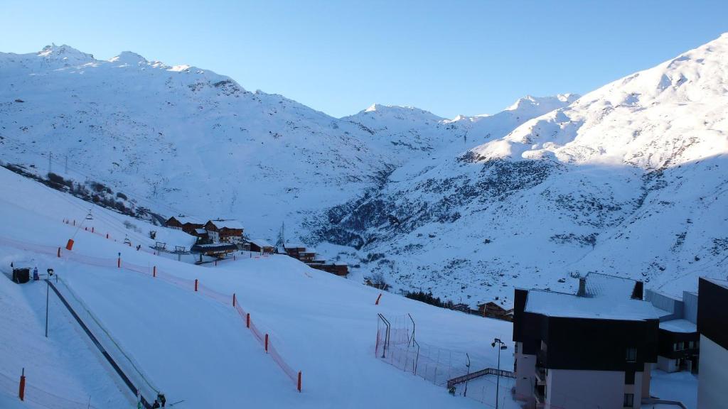 a snow covered mountain with a ski lodge on it at LES MENUIRES REBERTY in Les Menuires