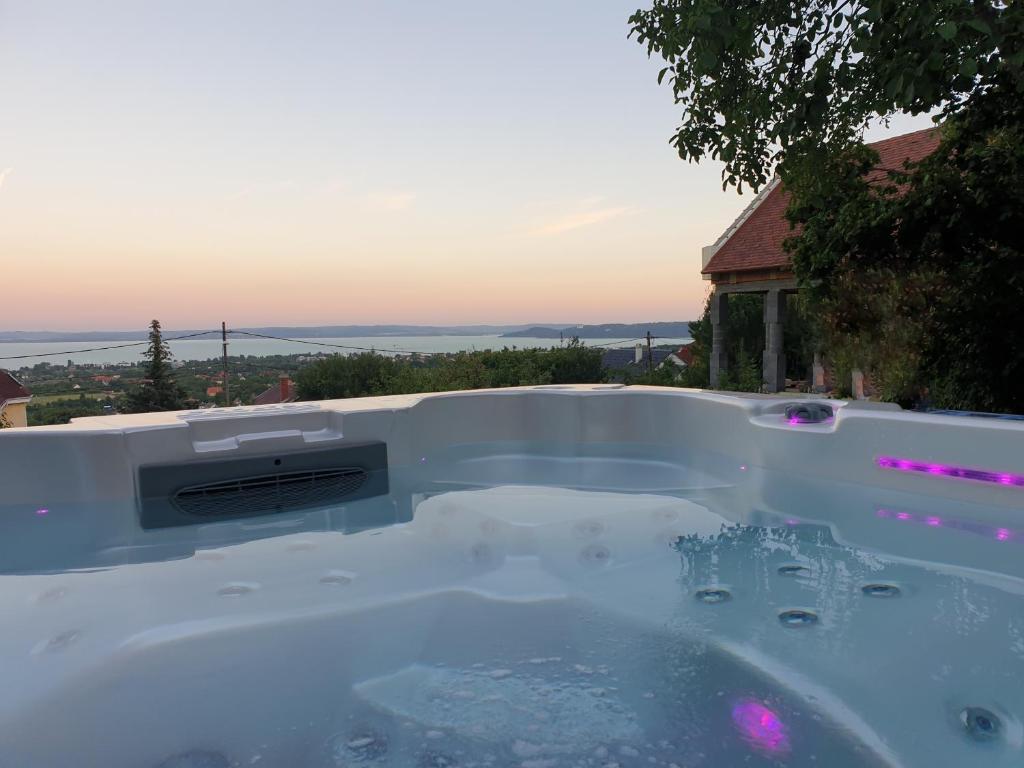 a jacuzzi tub in the backyard of a house at Lakeview Apartments Balatonfüred in Balatonfüred