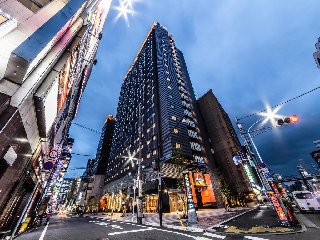 a tall building in the middle of a city at APA Hotel Higashi Shinjuku Kabukicho Tower in Tokyo