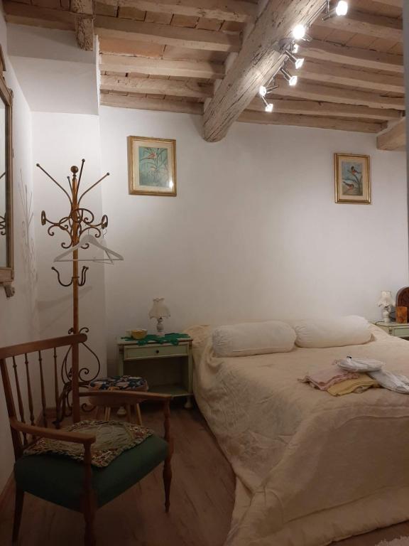 a bedroom with a bed and a chair and a table at MY HOME SCARPERIA in Scarperia
