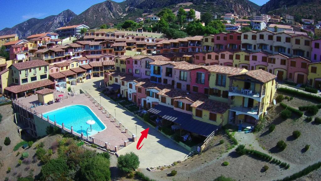 an aerial view of a resort with a swimming pool at Villetta bordo piscina vista mare Wi-Fi Gratis in Nebida