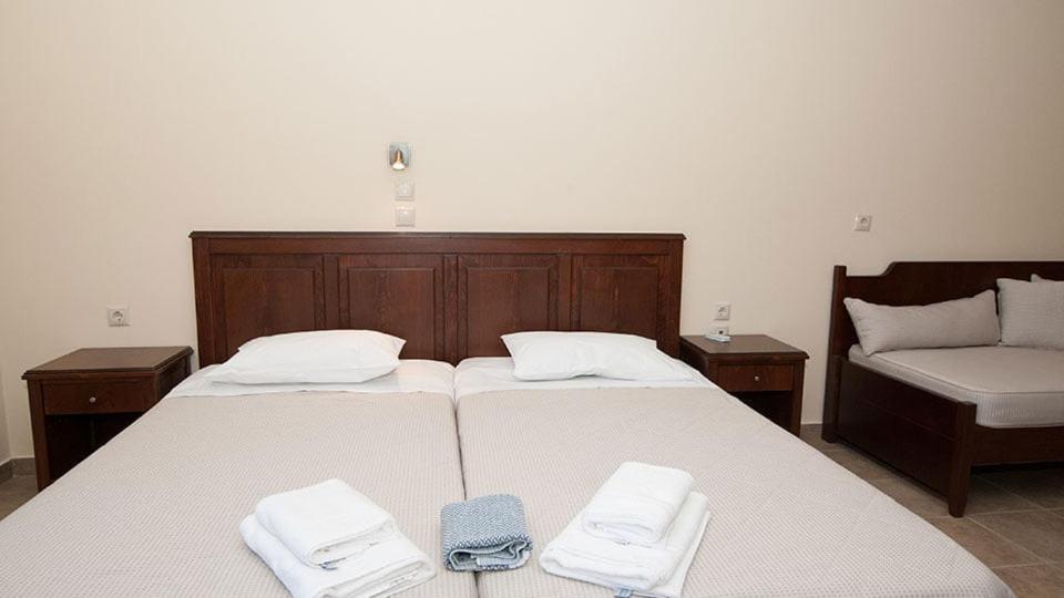 Łóżko lub łóżka w pokoju w obiekcie Anopoli Rooms