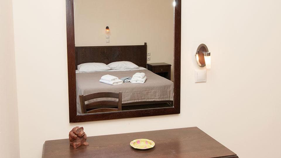Łóżko lub łóżka w pokoju w obiekcie Anopoli Rooms