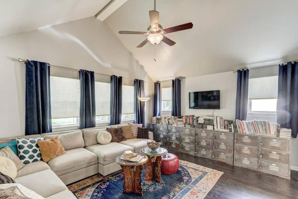 a living room with a couch and a ceiling fan at Vals Eclectic Classen Cottage in Oklahoma City
