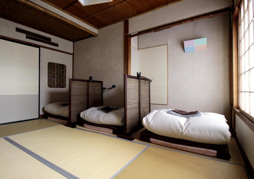Postel nebo postele na pokoji v ubytování Izumo guesthouse itoan