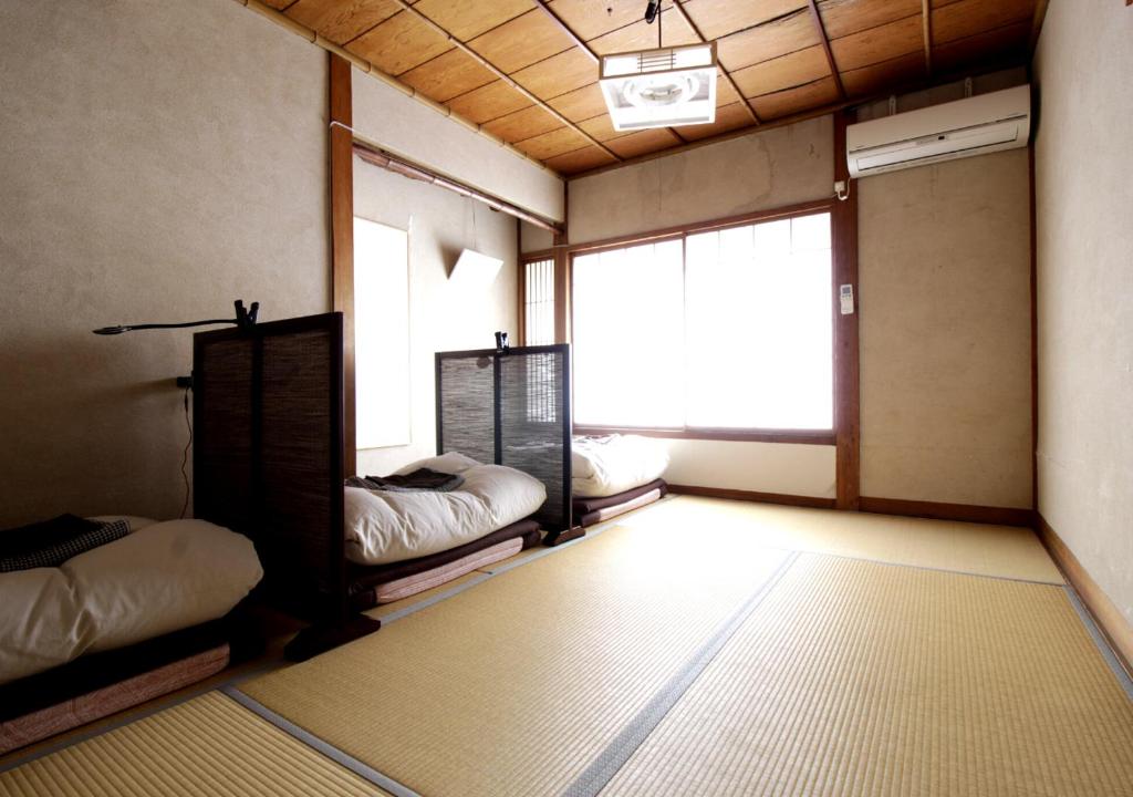 Postel nebo postele na pokoji v ubytování Izumo guesthouse itoan